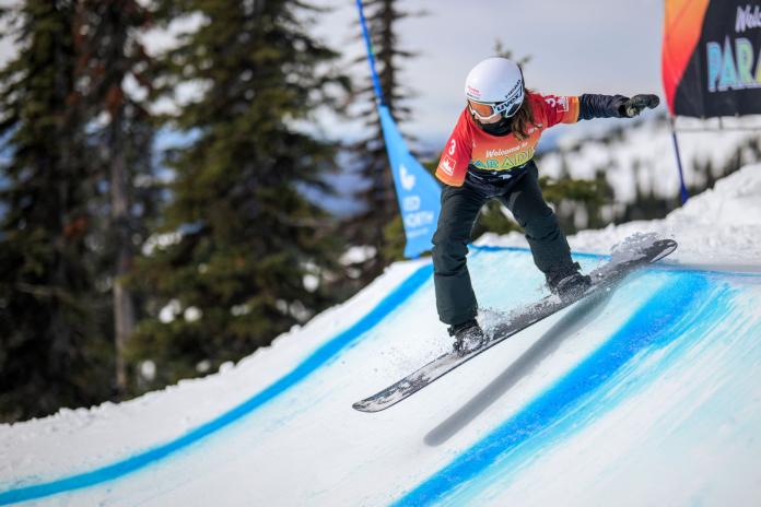 A female Para snowboarding athlete in action